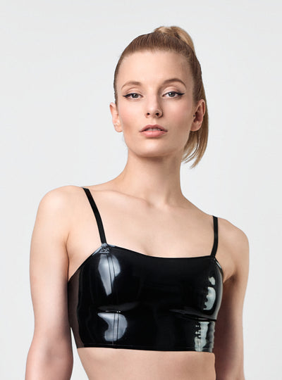 Model wearing Strict Latex Crop Top in black latex with slim straps and minimalist silhouette. Handcrafted in Berlin.